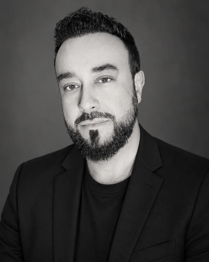 Black-and-white portrait of Shams C.