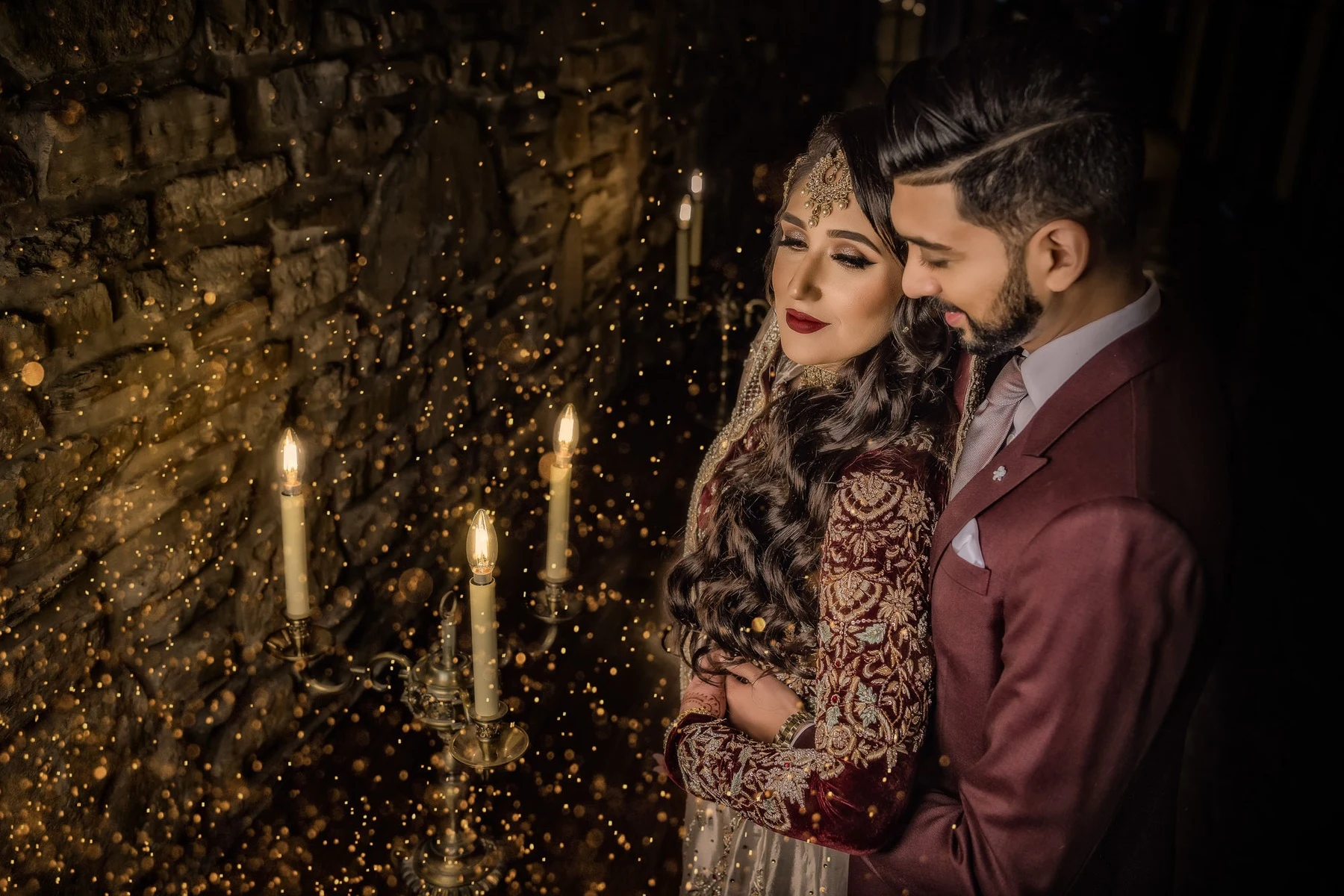 A wedding couple beneath warm decorative lights
